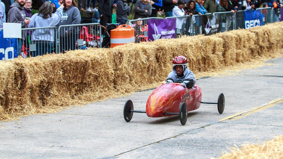 Spectators watch as the car prepared by the Bloomfield Community Center competes in last year’s Magnolia Soap Box Derby. The derby returns Saturday.