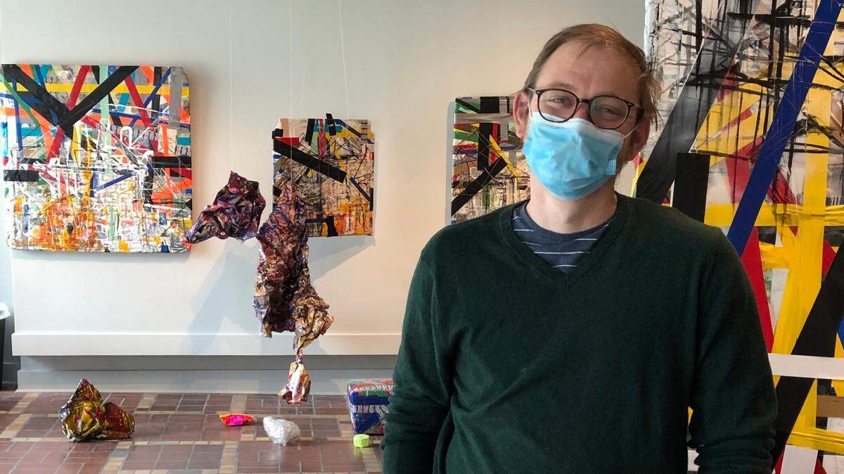 Ben Dunn, director of Mercer University’s McEachern Art Center at 332 2nd St., stands among works of the “TAUT: Recent MFAs Revisited” exhibit which now features artists talks online on Thursdays at 4 p.m. through mid-February.