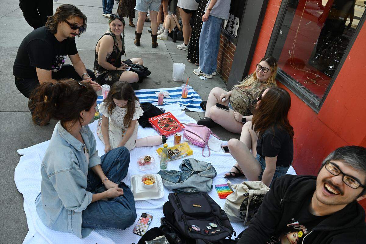 Fans wait in line outside Fatty’s Pizza to get wristbands for a surprise pop-up Phoebe Bridgers concert on Saturday, May 16, 2026, at Robins Financial Capitol Theater in Macon, Georgia. 