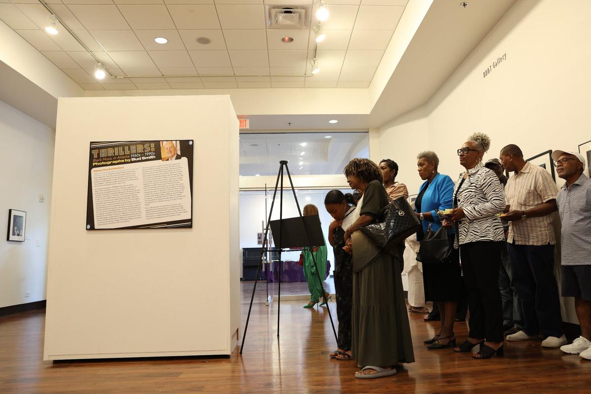 Spectators listen as photographer Bud Smith discusses his career at the opening reception for “Thrillers: Black Music in Atlanta 1960s-1990s” on Sunday, July 28, 2024, at the Tubman Museum in Macon, Georgia. The Tubman’s newest exhibit features decades of Black music photography from Atlanta based photographer Bud Smith.