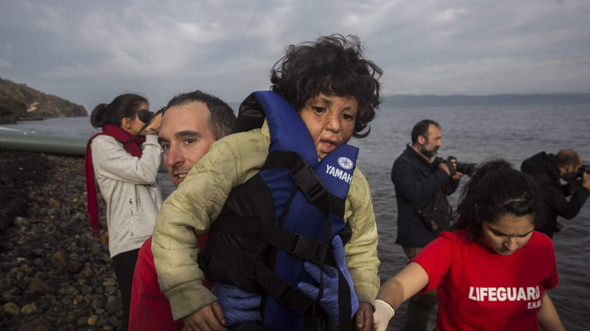 SANTI PALACIOS/THE ASSOCIATED PRESSA volunteer helps a boy, whose father says his face was burned during a bomb explosion in Aleppo, Syria, after he crossed the Aegean sea on a dinghy from Turkey to the northeastern Greek island of Lesbos with other refugees and migrants in November.