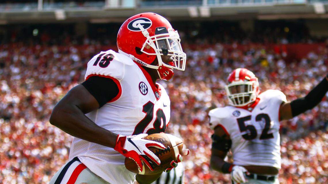 Georgia defensive back Deandre Baker (18) leads a break away to score Georgia’s first touchdown against South Carolina in Williams-Brice Stadium in Columbia, S.C., on Sept., 8.