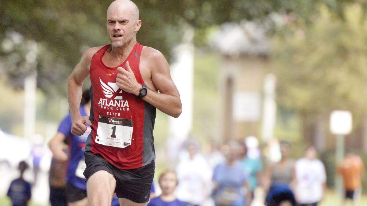 JASON VORHEES/THE TELEGRAPH Macon, GA, 09/07/2015: 
 10K winner Alan Black runs through Central City Park to the finish line during the 39th Macon Labor Day Race Monday morning.