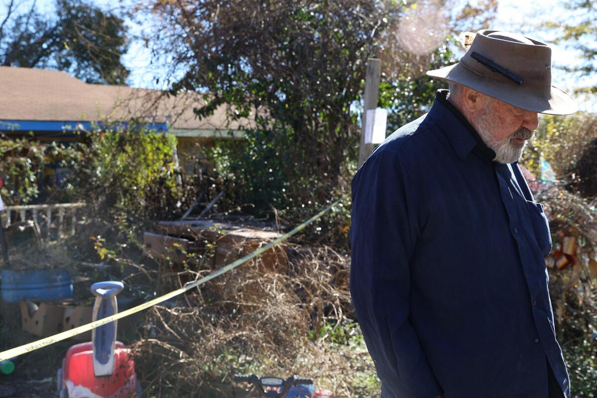 Eric Pfeiffer, who lives in the house across the street, stands in front of a condemned property on Angus Boulevard on Thursday, Dec. 12, 2024, in Warner Robins, Georgia. Pfeiffer said that he has placed 60 pounds of poisoned corn around his house with hopes of keeping the rats from across the street from getting inside his house.