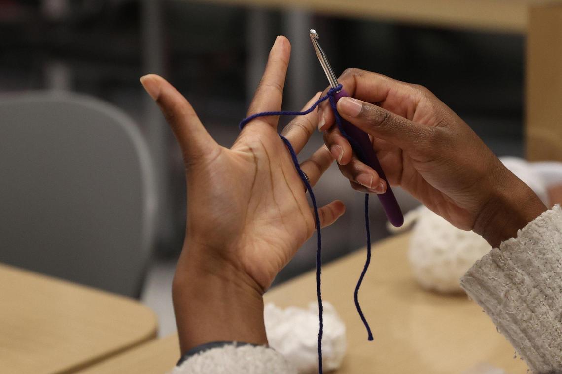Judah David Creations owner Darice Oppong demonstrates one method for how to complete a slip knot during NICU support group on Wednesday, Dec. 19, 2024, at the Beverly Knight Children’s Hospital in Macon, Georgia. Oppong teaches her beginner crochet class to the support group for NICU parents, a resource she said she needed while in NICU with her son Judah David Oppong last year.