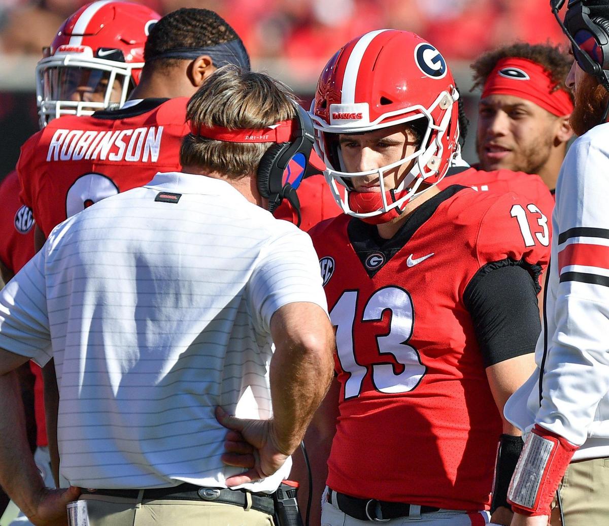DONN RODENROTH,Athens, Georgia, 10/16/2021: Georgia Head Coach Kirby Smart has a few words with quarterback Stetson Bennett during a time-out Saturday in Athens as the Bulldogs hosted the Kentucky Wildcats.