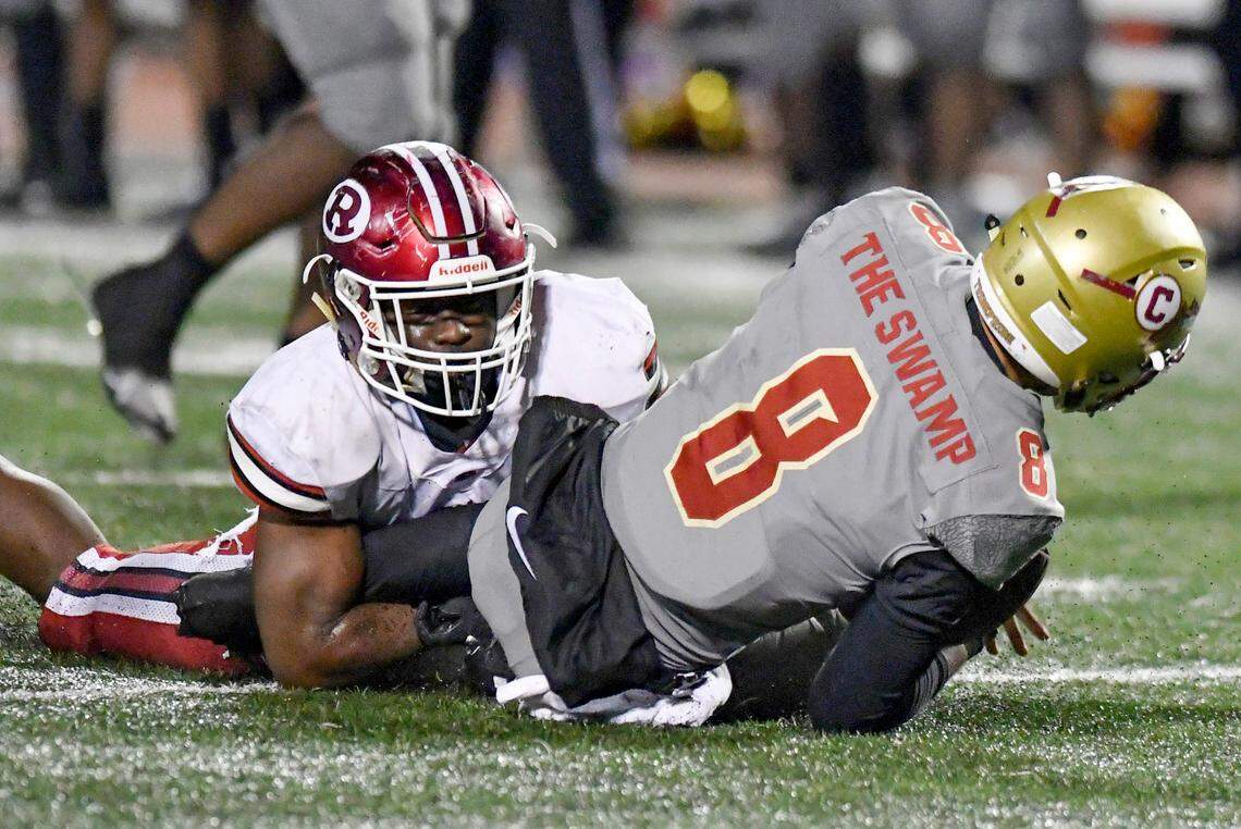 Warner Robins’ Elijah Antonio (9) sacks Creekside quarterback Vinson Berry (8) during the Demons’ 31-28 overtime win Friday night.