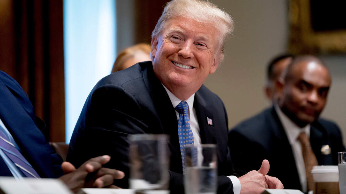 President Donald Trump smiles during a meeting with inner city pastors in the Cabinet Room of the White House in Washington on Wednesday.