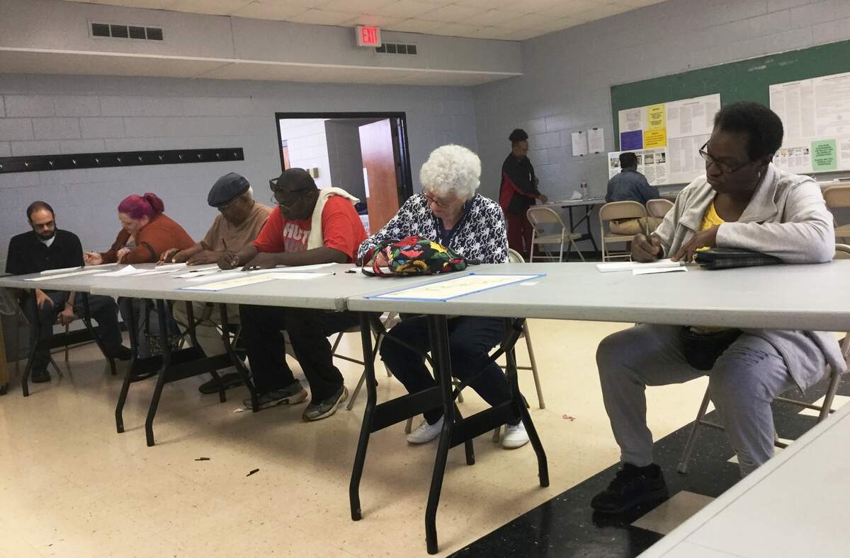 Voters fill out paperwork before casting ballots Tuesday at the Warner Robins Recreation Department.
