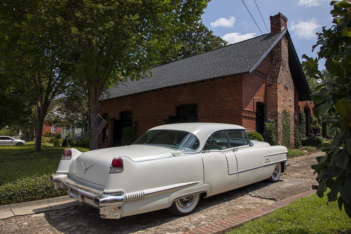Their classic car, Vinita, is parked in their driveway in downtown Macon.