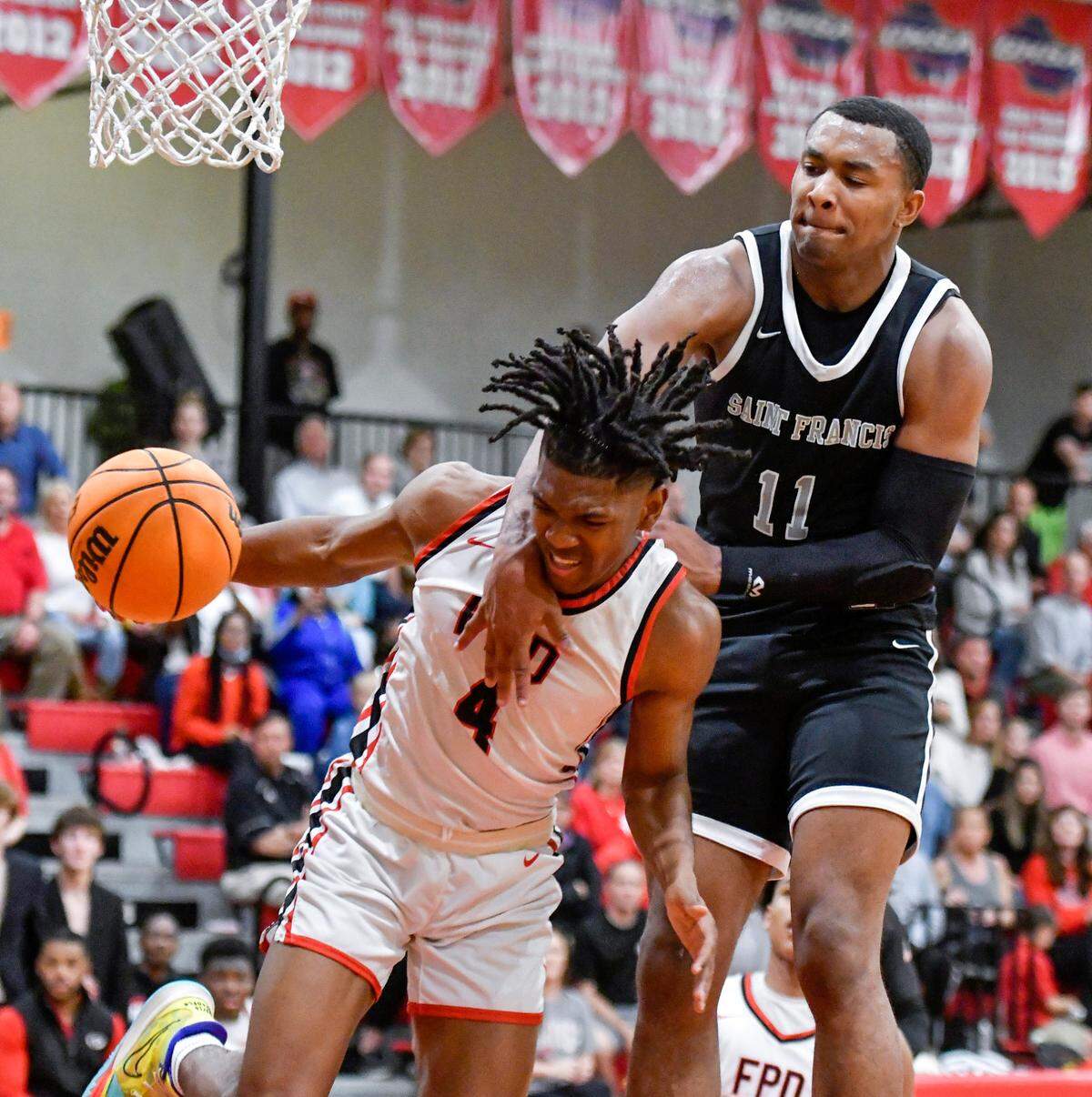 FPD’s Jay King (4) is fouled by St. Francis’ Jase McCullough (11) during their GHSA 1A (Private) Elite 8 game Wednesday night. .