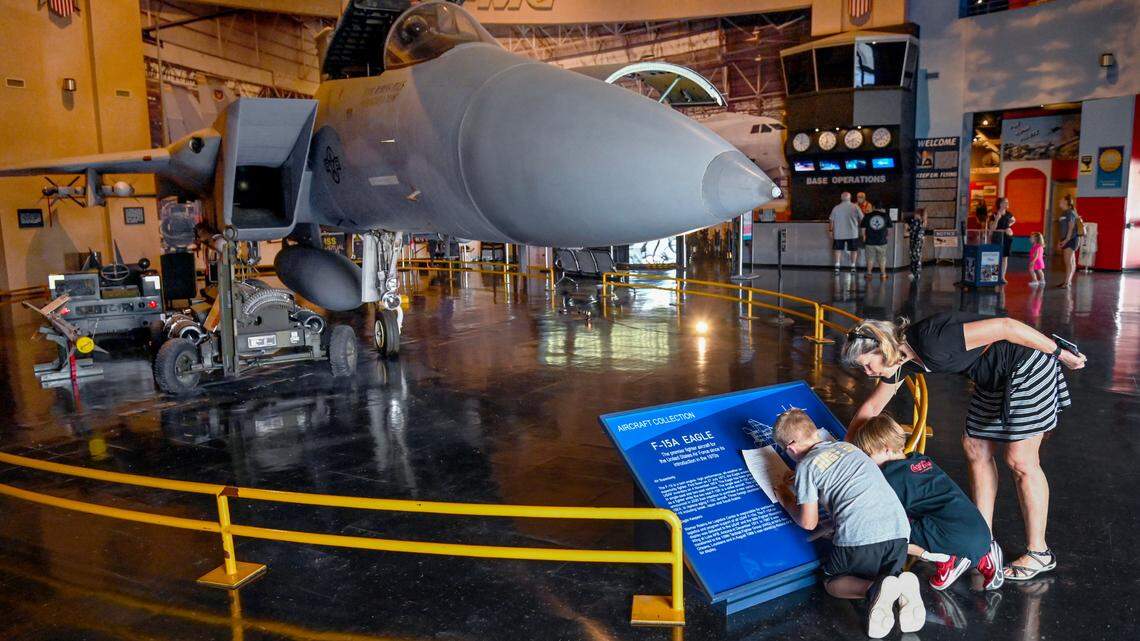 Becky Zweig helps her grandson JB Carter, left and his friend Caleb Daniel with a scavenger hunt in front of the F-15 on display at the Museum of Aviation in Warner Robins. The three were in town to watch the Nolensville, Tennessee team compete in the Little League Southeast tournament.