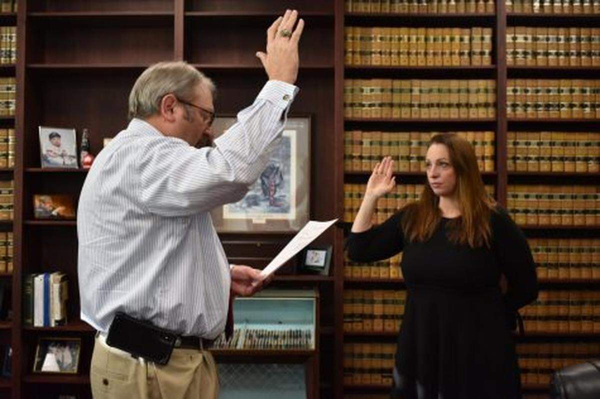 Judge Howard Simms, left, swears in Jessica Rock as a new special assistant district attorney for Bibb County who will concentrate on animal cruelty cases.