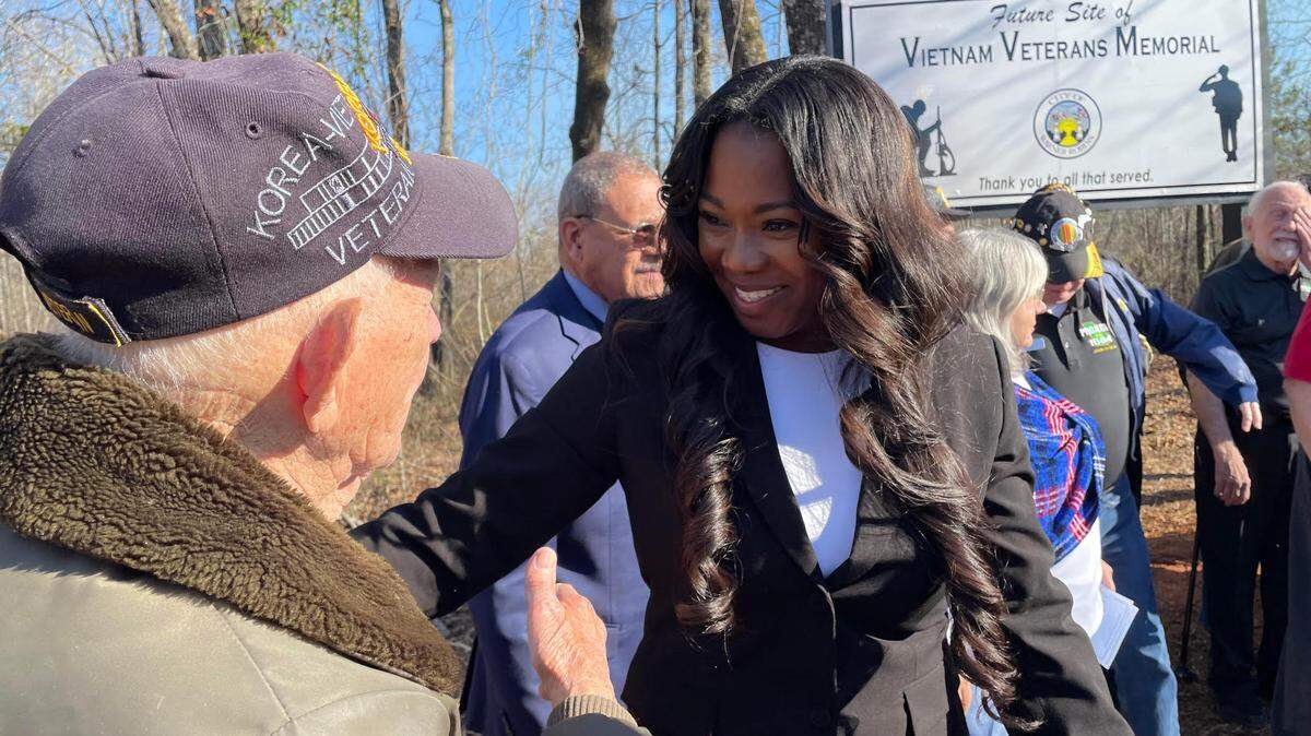 Korean War veteran Daniel W. Gatlyn gets a warm reception from Warner Robins Mayor LaRhonda Patrick at Friday’s land tribute event at the future home of a Vietnam Veterans Memorial in Warner Robins.