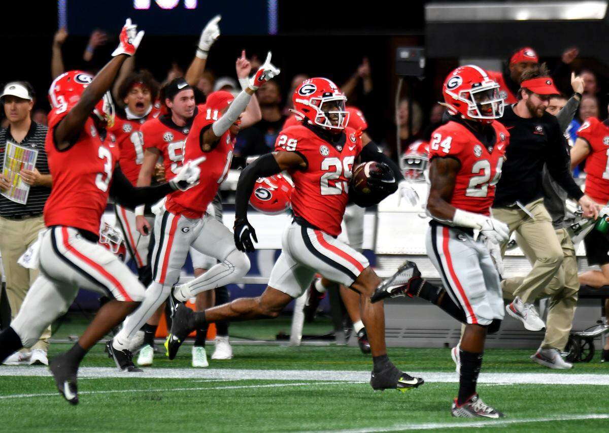 Georgia defensive back Christopher Smith (29) returns a blocked field goal 96 yards for a touchdown during the Bulldogs’ SEC Championship game against LSU Saturday in Atlanta.