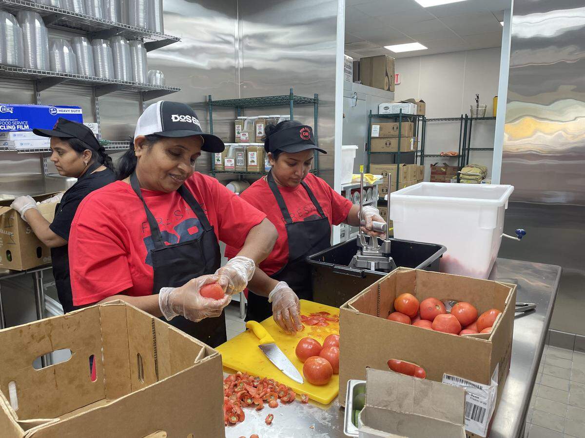 From left to right, Sandy Patel and Nikki Patel slice and dice tomatoes at the new DosBros Fresh Mexican Grill in Warner Robins. Kelly Patel, the co-owner of the franchise restaurant, is in the background.