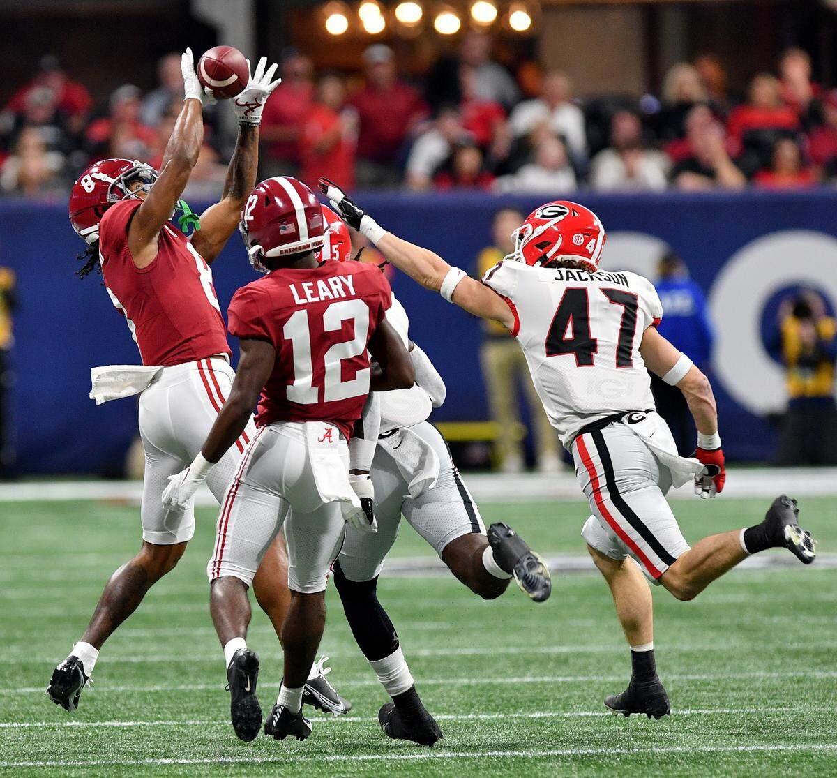 Alabama receiver John Metchie III (8) hauls in a reception Saturday during the Crimson Tides’ SEC Championship game against Georgia.