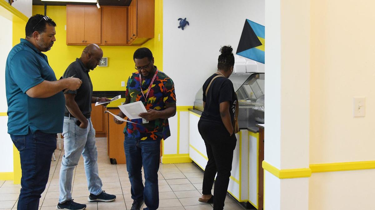 Customers wait in line inside a new restaurant that serves authentic Bahamian food on Thursday, Aug. 15, 2024, in Warner Robins, Georgia.