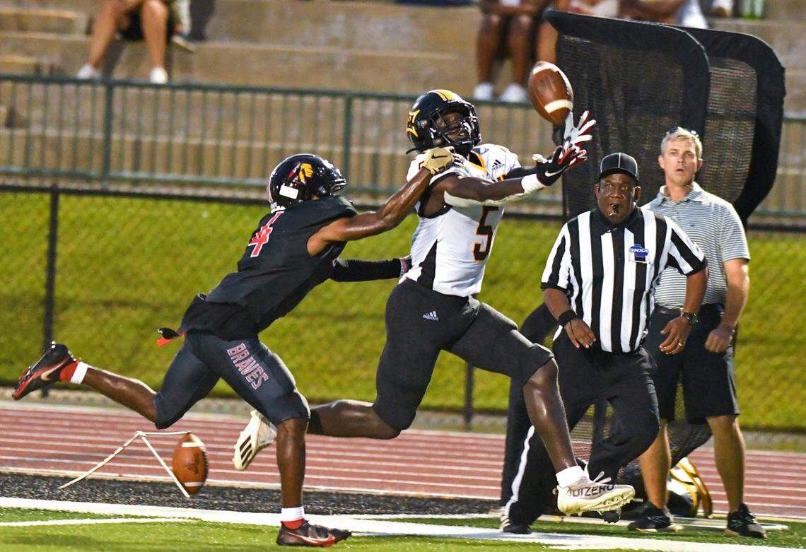 Peach County receiver Skeiler Manns (5) hauls in a deep pass from quarterback Colter Ginn (12) for a touchdown during the Trojans’ game at Baldwin Friday night.