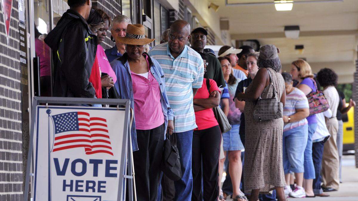 People wait in line to vote at the Macon-Bibb County Board of Elections office.