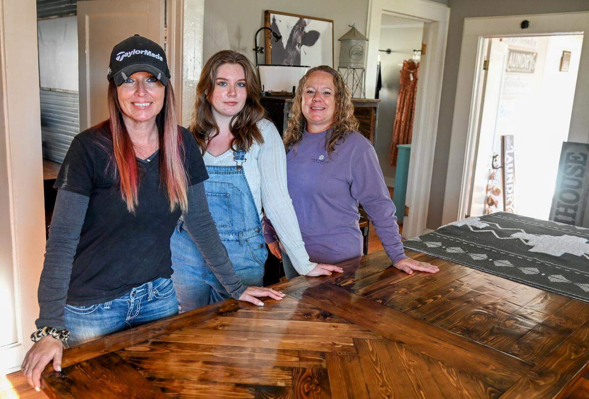 From right, Heather Peebles, owner of Penelope’s Farmhouse Furniture, with her daughter Paetyn and sister Tiffany Gordon at Peebles’ home decor storefront at 102 East Heritage Blvd. in Byron.