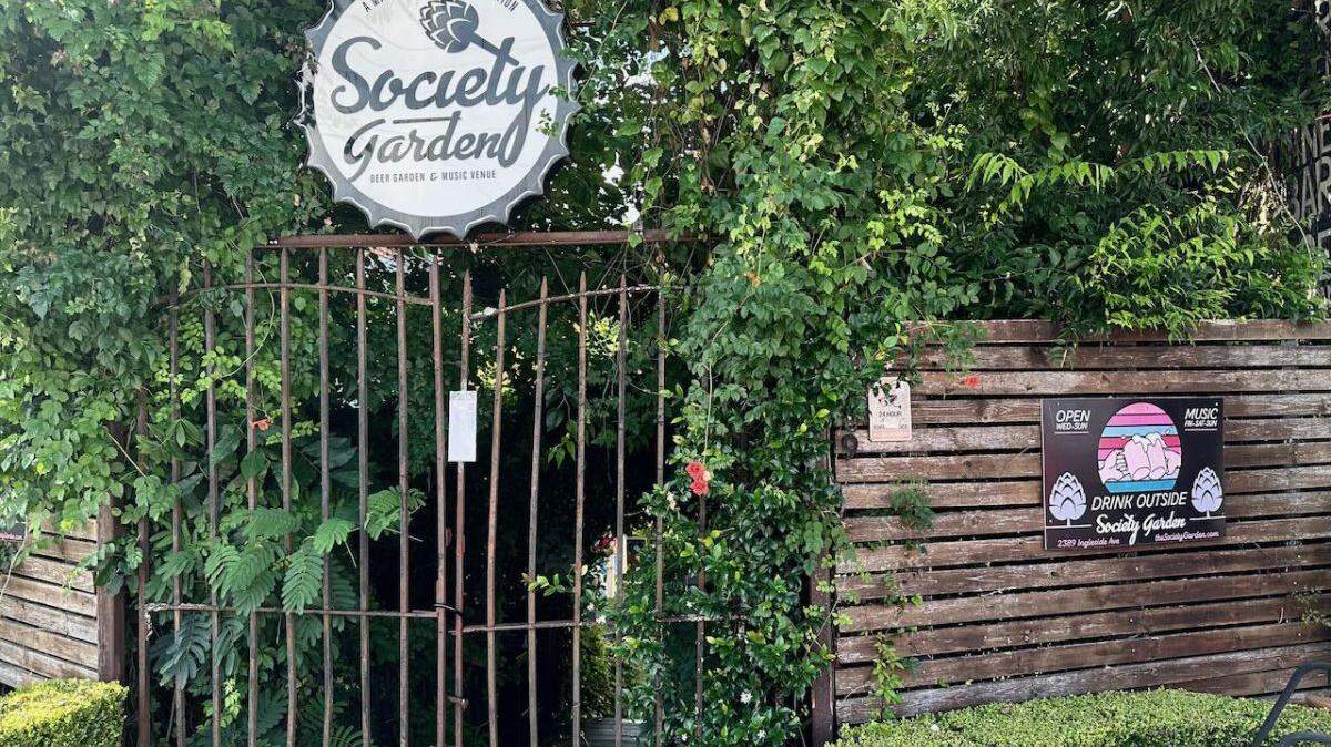 A notice from the Macon-Bibb County Health Department is posted on the gates of Society Garden after the board suspended their food service for nonpayment of fees.