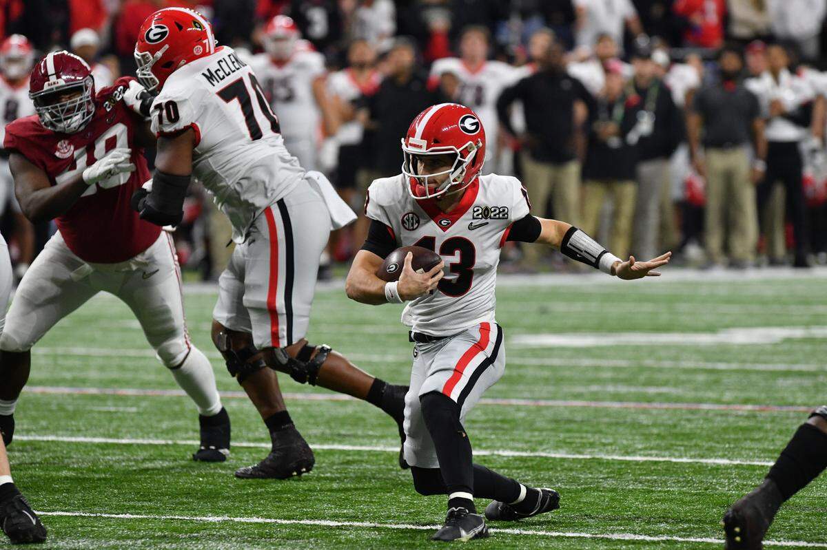 Georgia quarterback Stetson Bennett (13) runs for some yardage during the Bulldogs’ College Football Playoff National Championship game against Alabama Monday night.