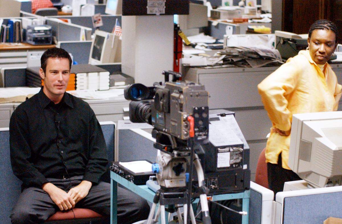Joe Kovac Jr. does a live broadcast for WMAZ in this Telegraph file photo as former executive editor Sherrie Marshall watches.