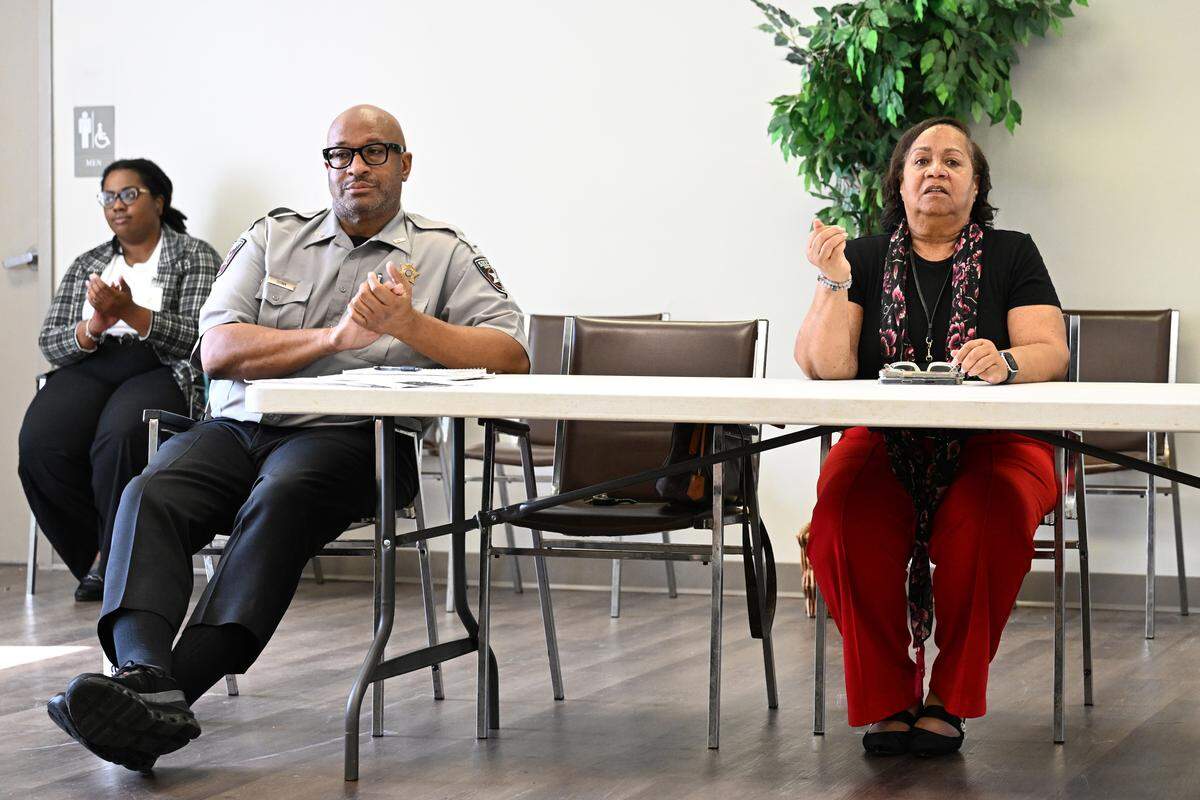 Bibb County Sheriff’s Office Lt. Chris Dunn (left) and Neighborhood Watch Coordinator Judy Gordon speak during a monthly Pendleton Homes Neighborhood Watch meeting on Thursday, Aug. 21, 2025, in Macon, Georgia. Pendleton Homes has seen the most crime reports out of all properties in the Macon Housing Authority since 2020, but has seen a significant decrease this year. 