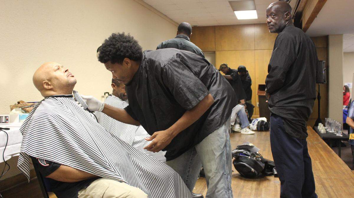 Garry Hollingworth, a barber student at Central Georgia Technical College, gives Army veteran Anthony Clark a shave at the annual stand down for veterans Friday.