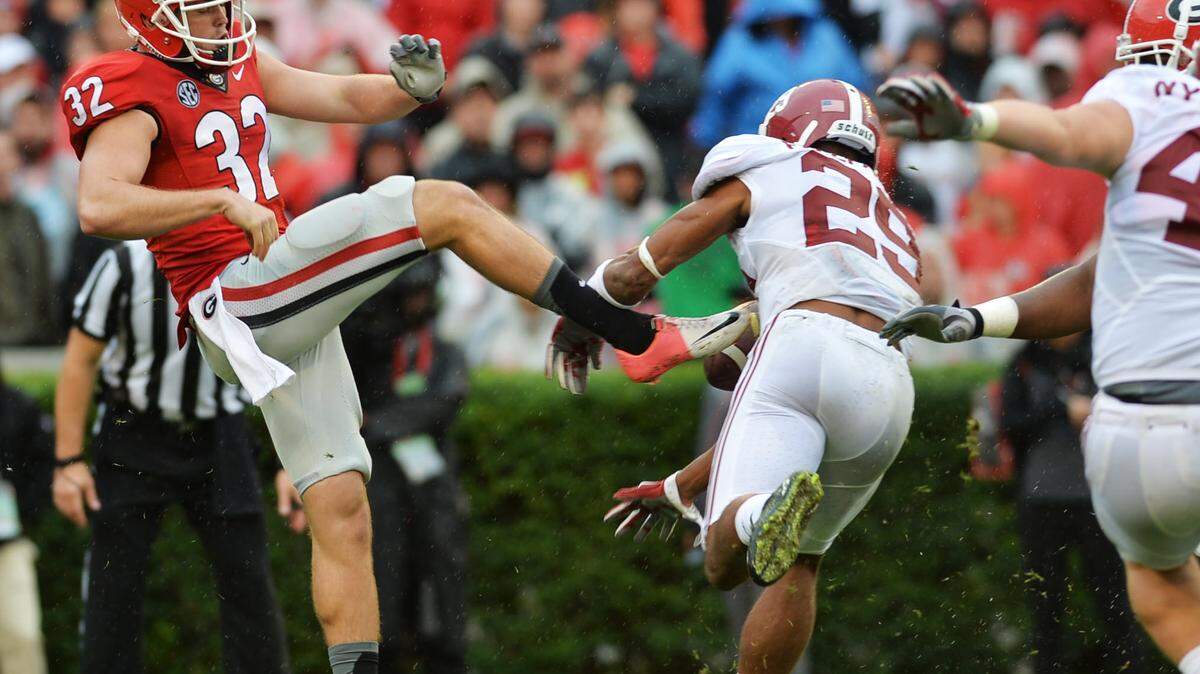 Alabama’s Minkah Fitzpatrick (29) blocks Georgia punter Collin Barber’s second-quarter punt that the Crimson Tide picked up and ran in for a touchdown.