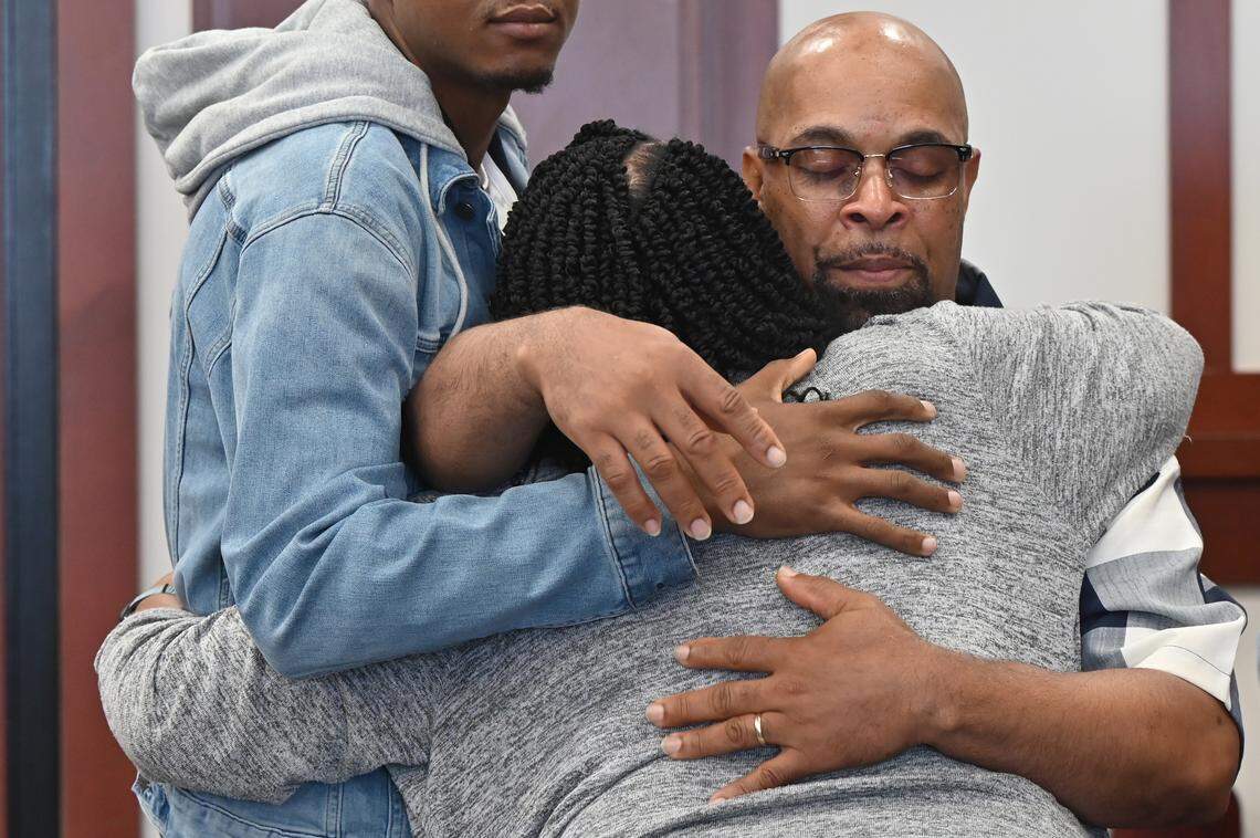 Nortrell Askew, older brother of Jessie Askew, hugs his cousin Amy Bawn, both from Warner Robins, after Jessie Askew’s life sentence without parole was modified on Friday, April 24, 2026, at Houston County Superior Court in Perry, Ga. 