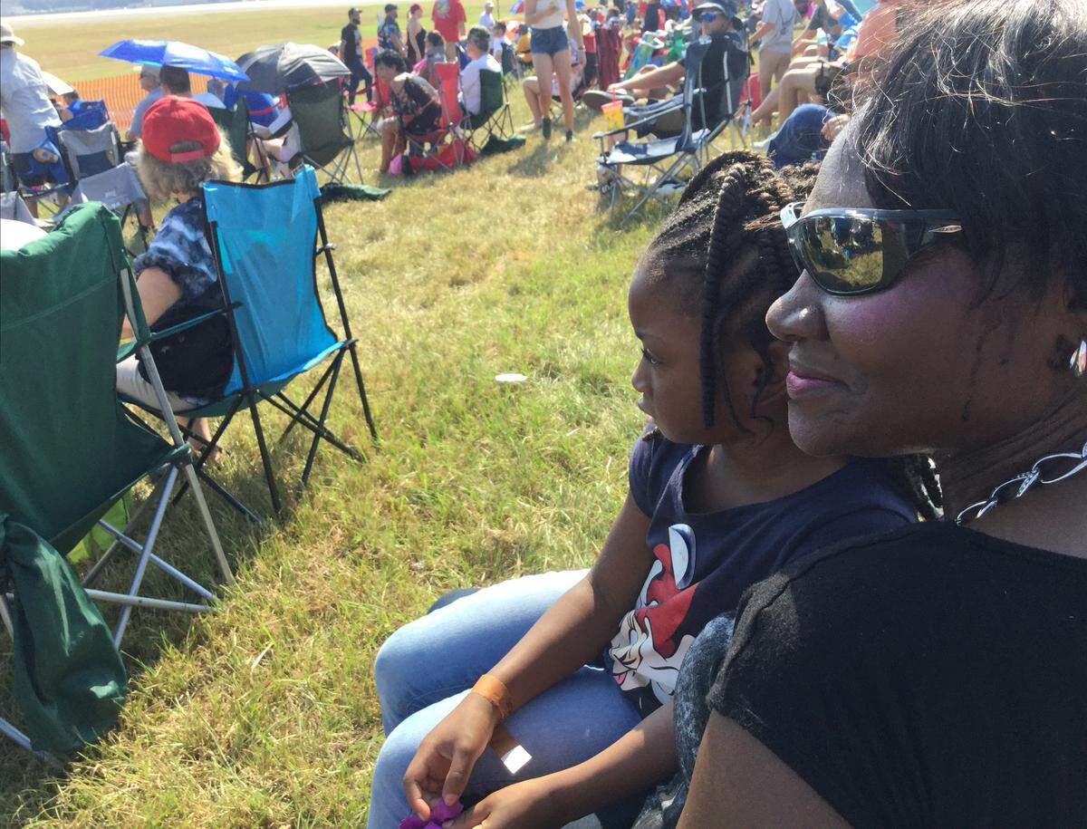 Diane Osayameh, enjoys the Thunder Over Georgia Air Show with her 5-year-old granddaughter, London, on Saturday, the first day of the two-day event at Robins Air Force Base.