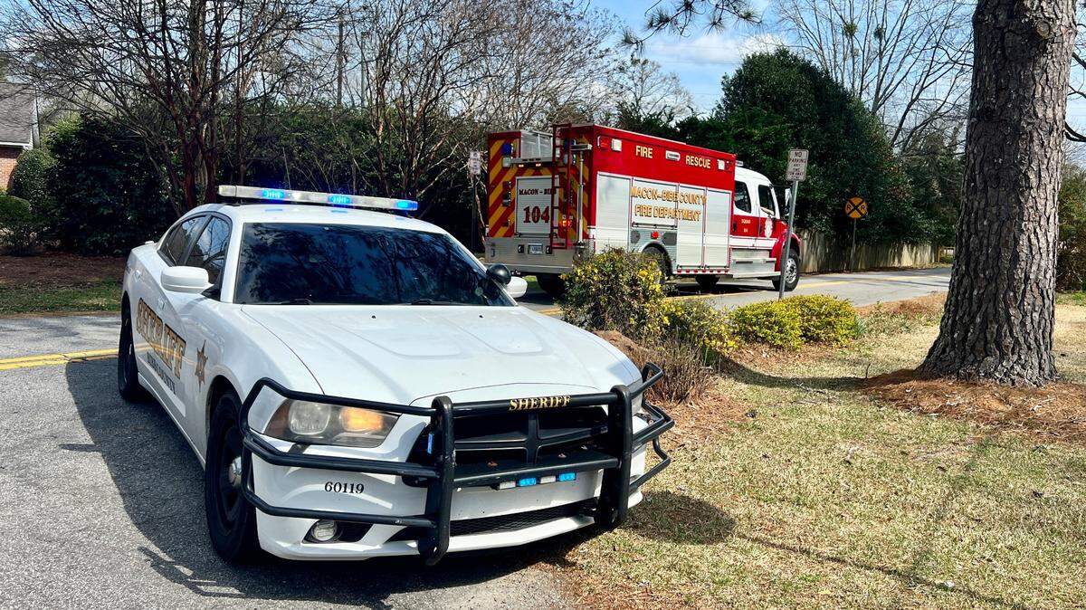 A Bibb County Sheriff’s car blocks the entrance to Amerson Park as police and DNR are still searching for a man who went missing in the Ocmulgee River late Wednesday.