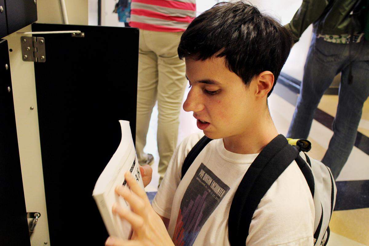 Timothy Jones grabs his music textbooks before his piano lesson with professor Ian Altman. Jones coordinates with disabilities service coordinator Carole Burrowbridge to order his braille books for classes. 
