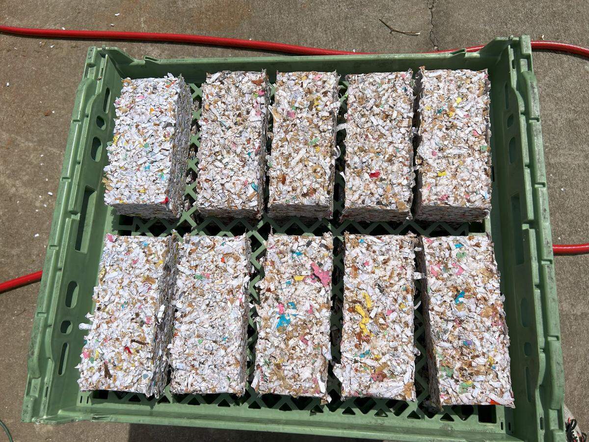 To make the paper fire starters, the participants in the recycling initiative shredded and soaked collected paper to create a pulp, then packed the pulp into solid bricks.