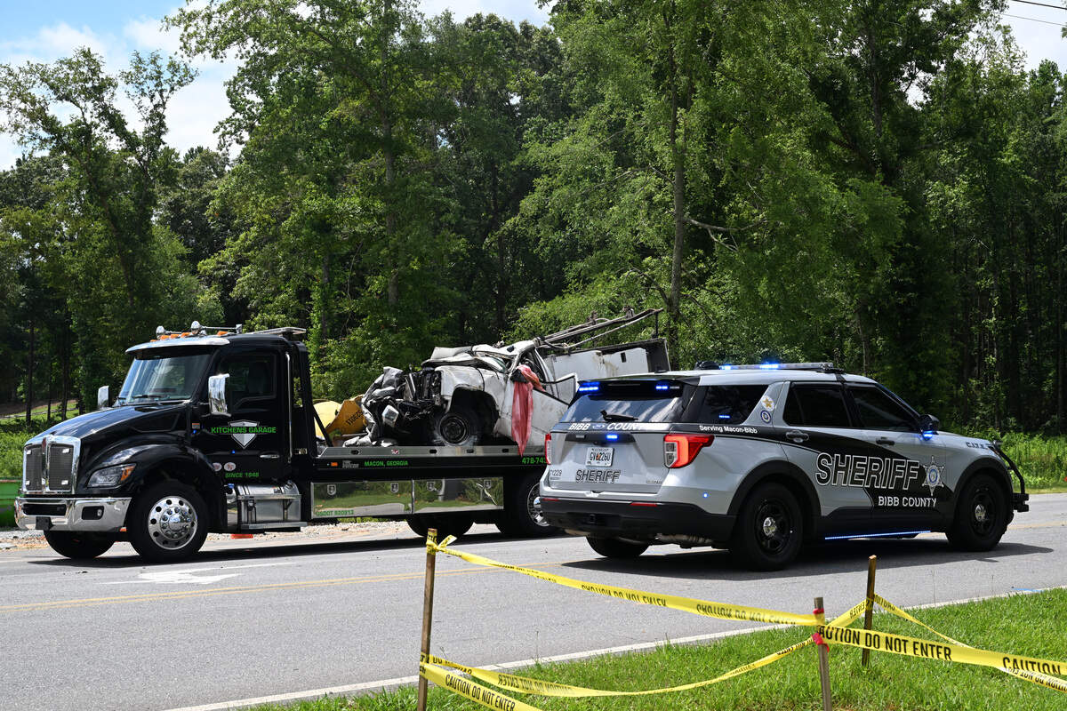 A utility truck sits on a tow truck after a fatal vehicle collision on Bass Road on Monday, June 15, 2026, in Macon, Georgia. The driver of the truck was pronounced dead at the scene after colliding with a commercial vehicle.