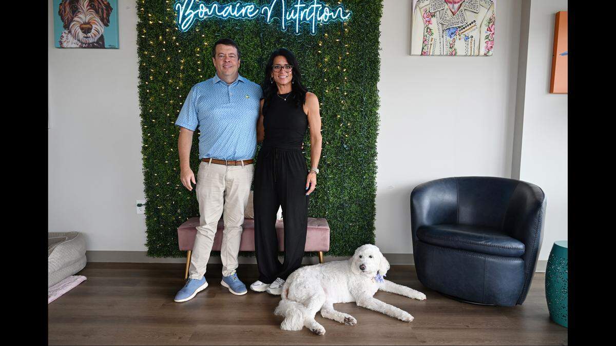 Bonaire Nutrition owners Kent Jordan and Laura Waters pose with their dog Daffy inside of their store in Warner Robins, Georgia. The new shop specializes in dietary-supplement drinks, including loaded teas, protein coffees and meal replacement shakes.
