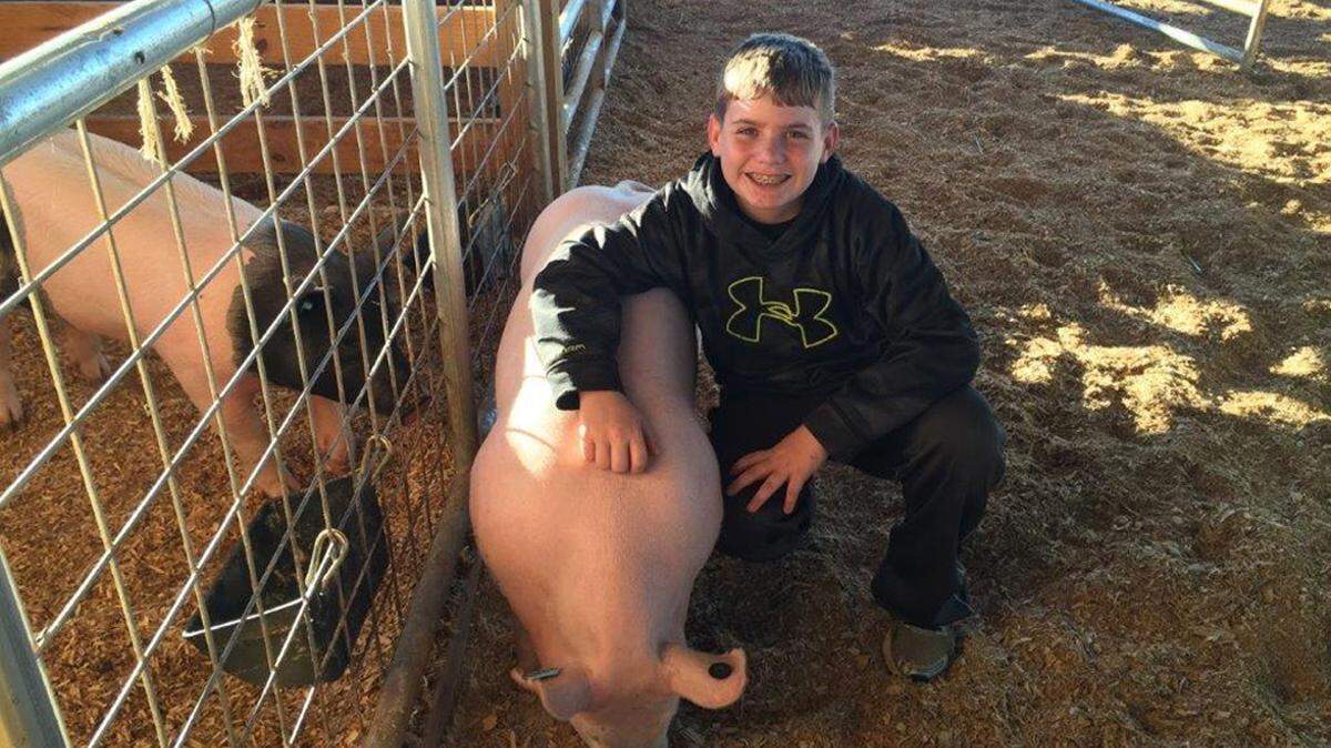 Camden Hicks and and his pig Winston.