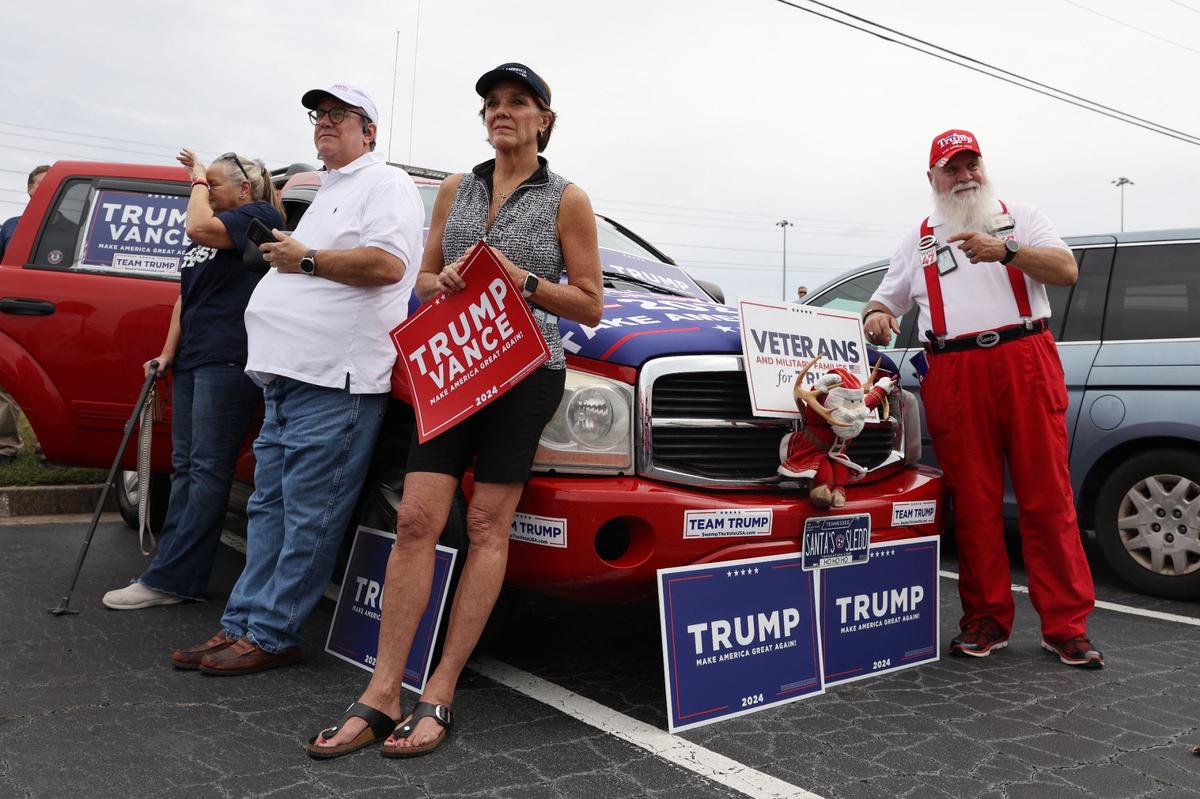 Trump Vance campaign bus tour attendees listen to speakers on Friday, Oct. 4, 2024, outside of the Bibb County GOP office in Macon, Georgia. The Trump Vance presidential campaign made a stop in Macon on a bus tour across Georgia beginning on Friday and traveling throughout the weekend with local and national Republican representatives.