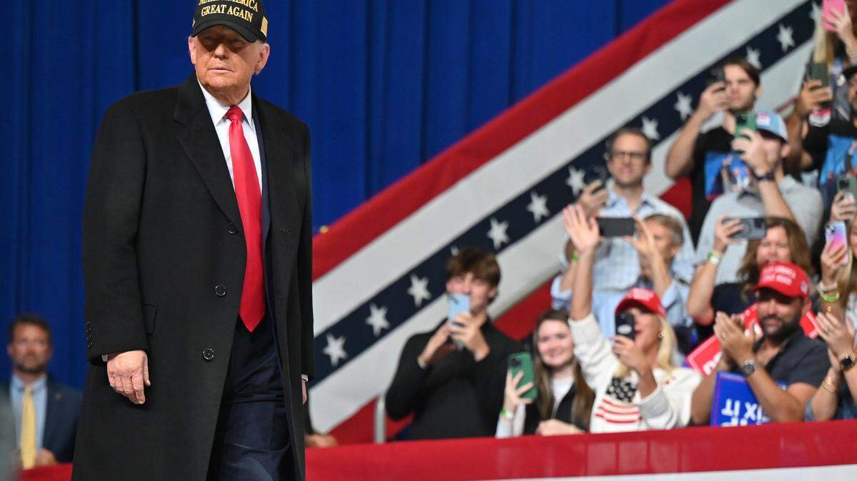 Republican presidential candidate Donald Trump walk out on stage at his “Make America Great Again” rally on Sunday, Nov. 3, 2024, at Atrium Health Amphitheater in Macon, Georgia. Trump visited Macon just two days before Election Day, highlighting his campaign and urging people to get out the vote. 