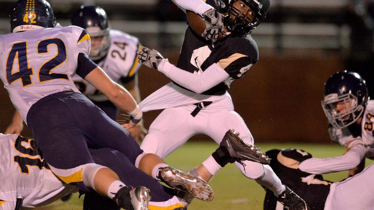 Mary Persons Bulldog Bruce McCall breaks through the Marist line Friday night in Forsyth.