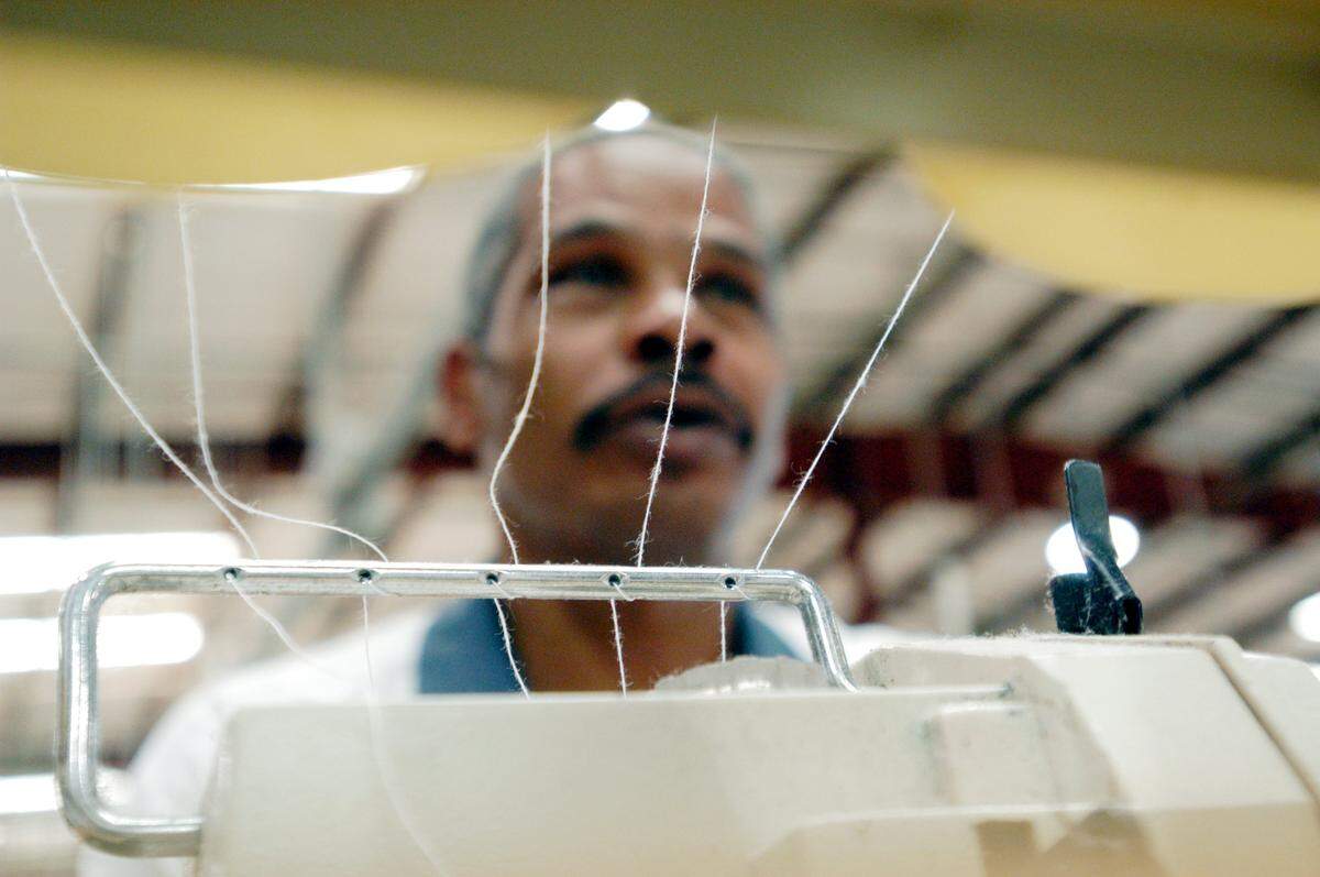 Lafayette Hall works on a sewing machine at Hancock County State Prison.