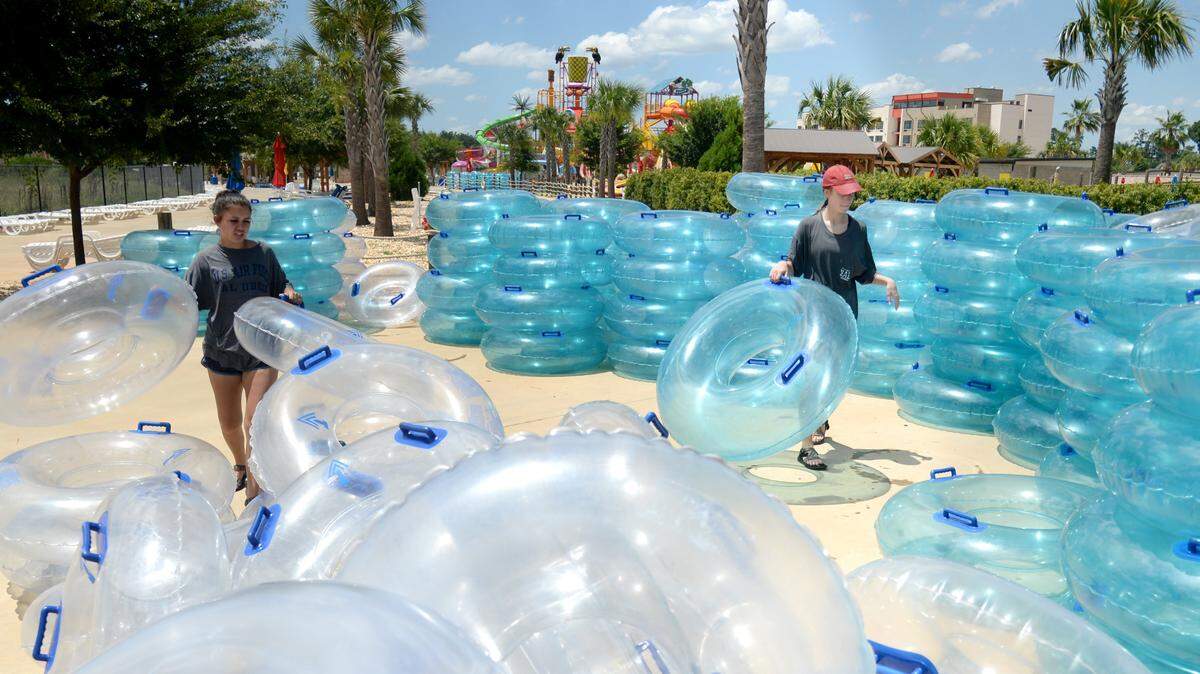 Mikayla Wellborn, left and HK Magee assorts tubes at Rigby’s Water World while helping prepare for the park’s opening day in this Telegraph file photo.