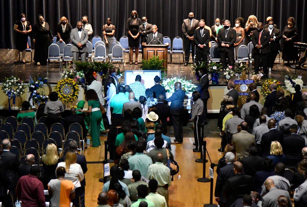 The family of former Bibb County deputy Christopher Knight walks into the Macon City Auditorium for funeral services.