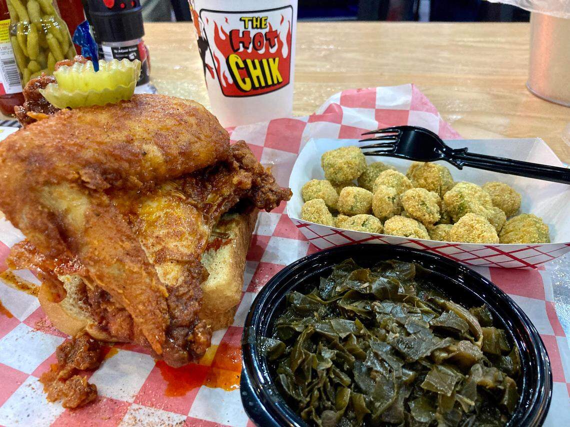 A fried chicken plate at The Hot Chik of a breast and a wing, Southern collard greens, fried okra, bread and pickles.