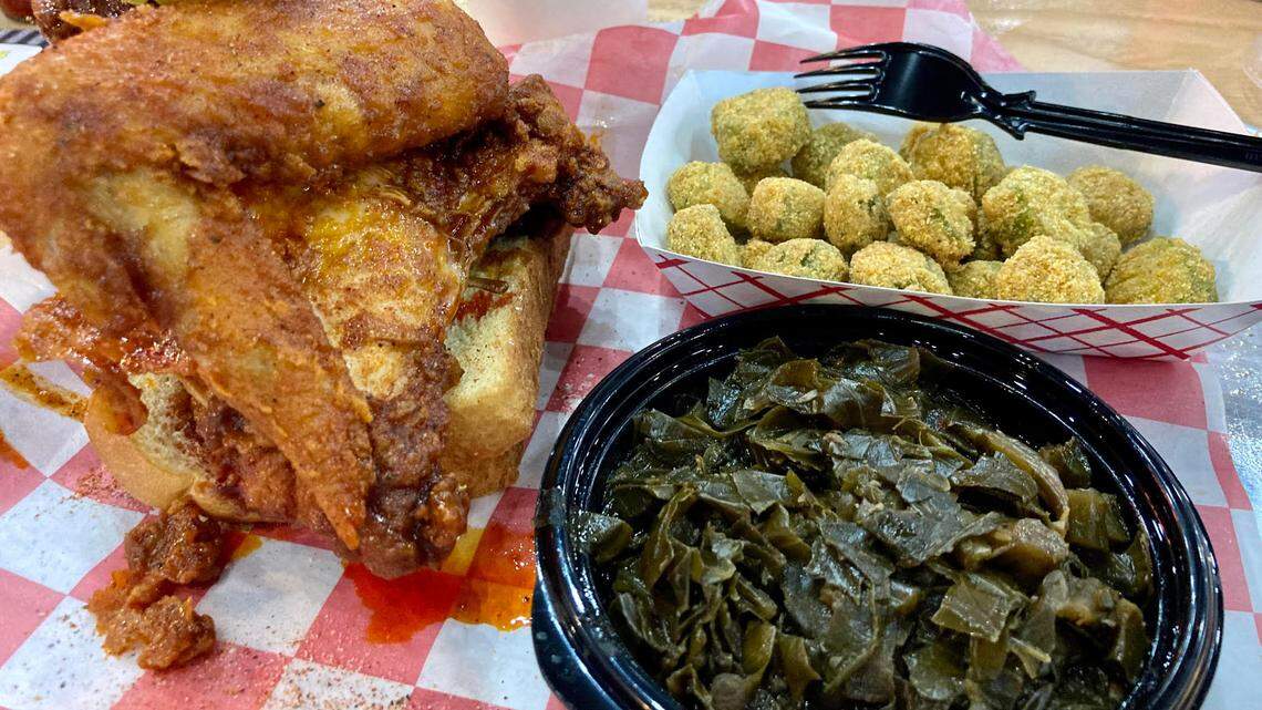 A fried chicken plate at The Hot Chik of a breast and a wing, Southern collard greens, fried okra, bread and pickles. The new restaurant has closed.