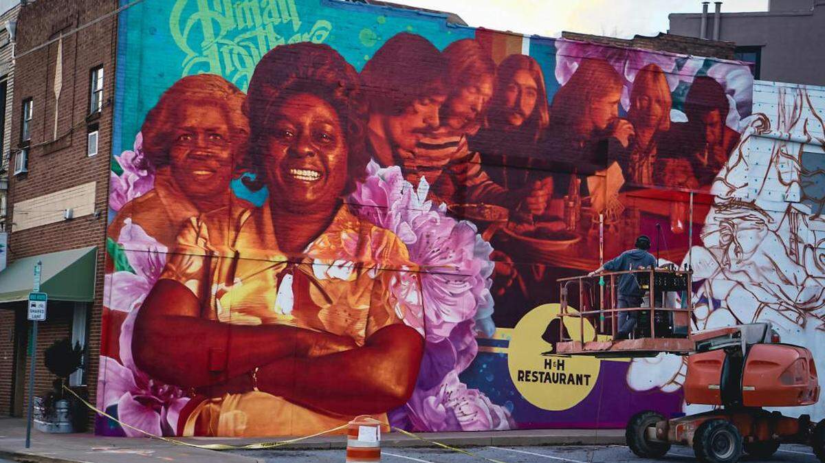 Artist Steven Teller at the mural he’ll finish next week at the H&H Soul Food Restaurant depicting original members of the Allman Brothers Band and the restaurant’s originators, Inez Hill and Louise Hudson.