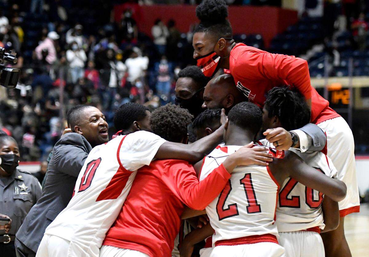 Baldwin players and coaches celebrate their 54-53 last second over Fayette County during the GHSA 4A State Championship game Wednesday night in Macon.
