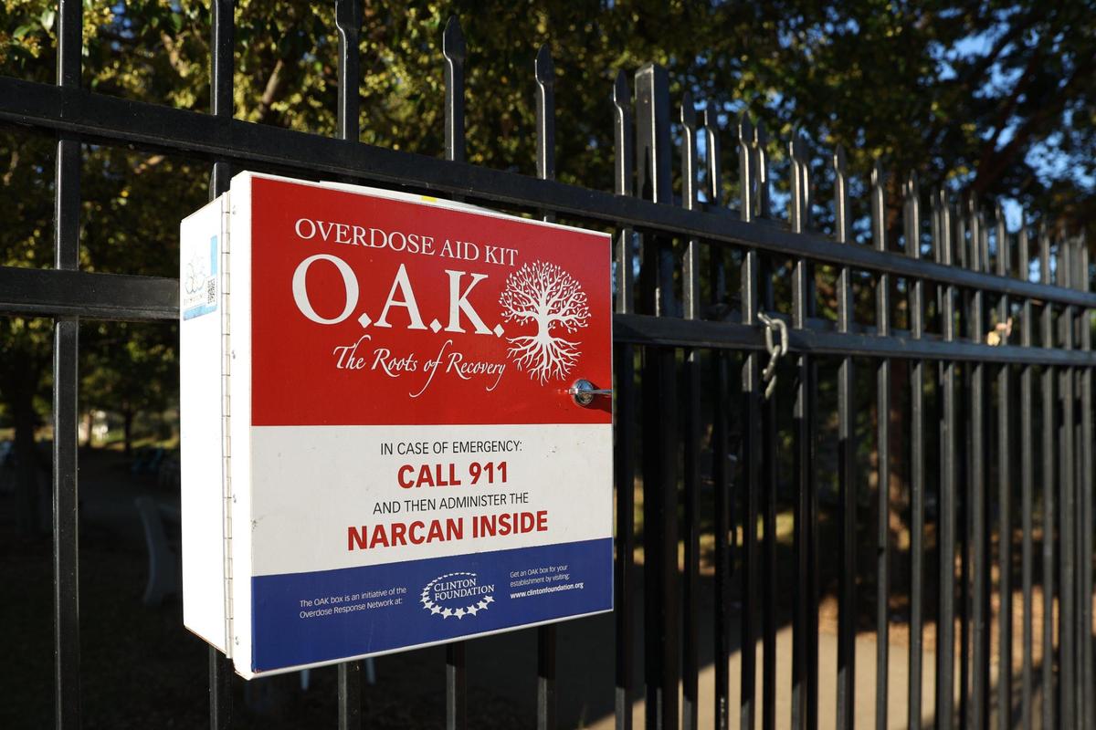 An Overdose Aid Kit sits on the fence outside of Daybreak on Friday, Oct. 18, 2024, in Macon, Georgia. The box is one of four across Macon supported by nonprofit Macon Recovers and allows anyone to access Narcan and fentanyl testing kits for free.
